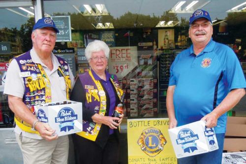 Dave and Dawn Hansen and Lions president Bill Pyle at the SL and District Lions annual bottle drive